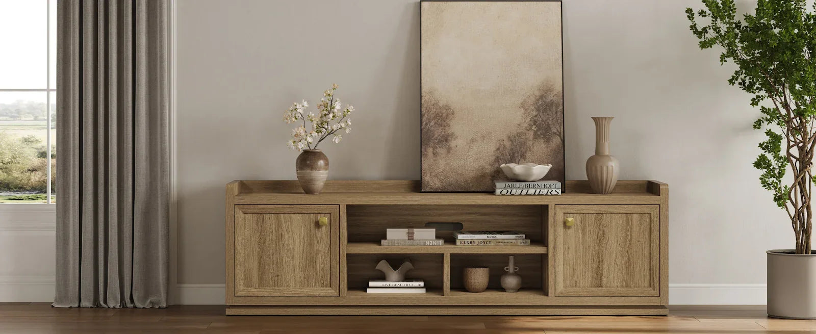 Modern living room with light wood sideboard, minimalist art, vases, books, and potted plant