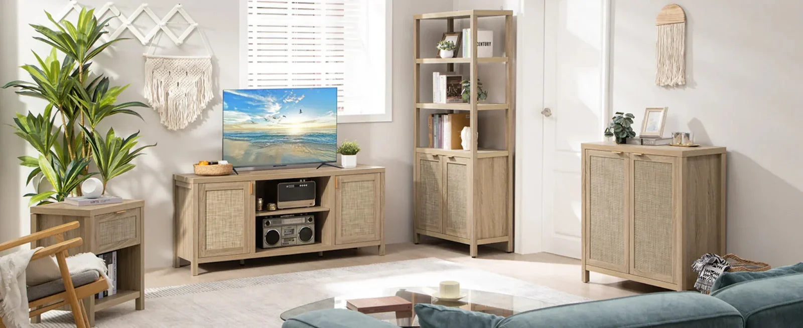 Modern living room with light wood furniture, woven accents, indoor plants, and a TV console