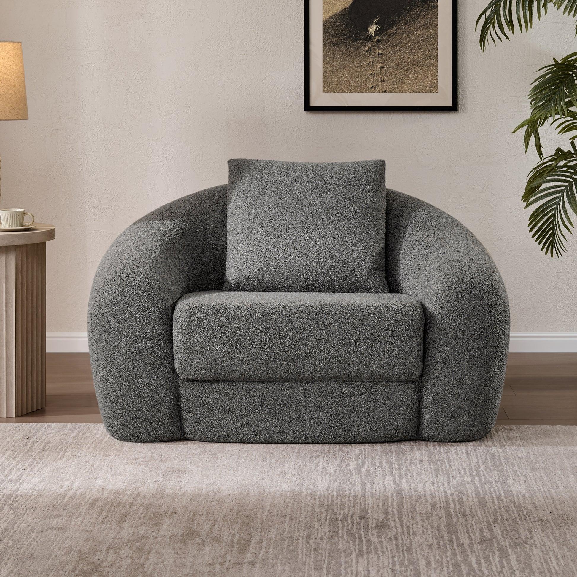 Modern gray boucle sofa chair with curved arms in cozy living room