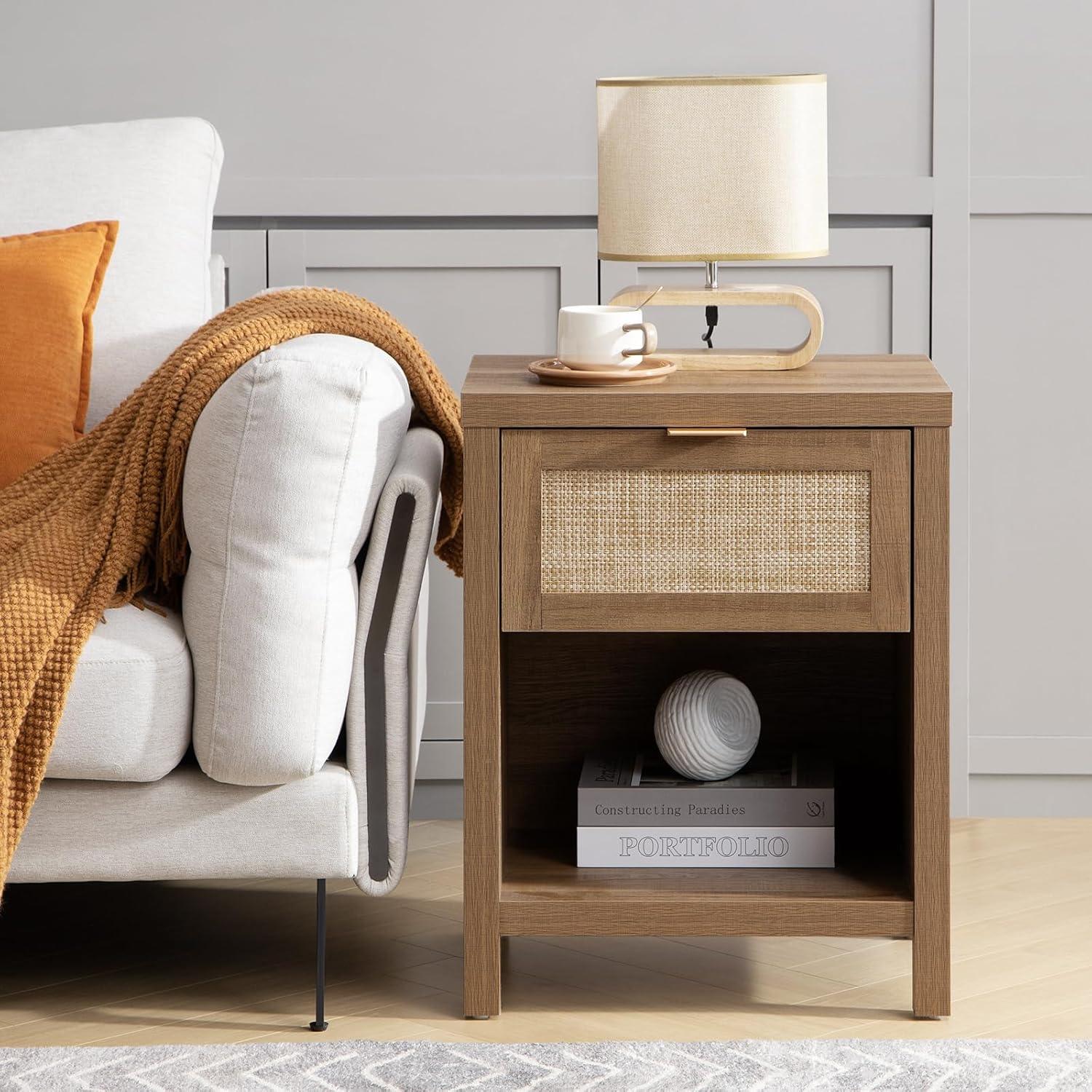 Modern wooden nightstand with rattan drawer, table lamp, and books beside beige sofa