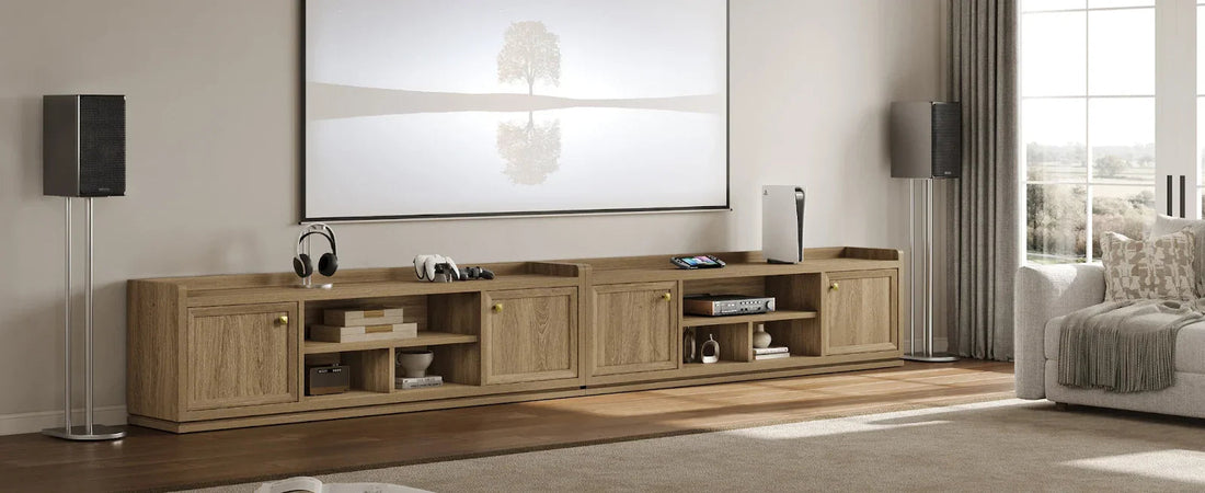 Modern living room with wooden TV console, large artwork, speakers, and gaming devices