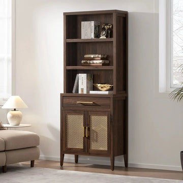 Tall wooden bookcase with rattan cabinet doors, books, and decor in a modern living room