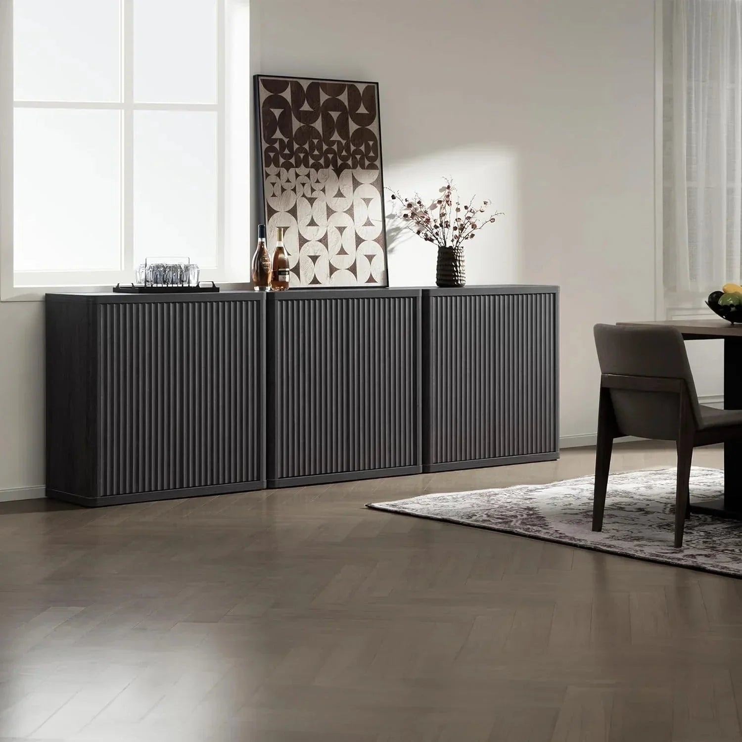 Modern dark wood buffet cabinet in a minimalist dining room, decor accents and wall art