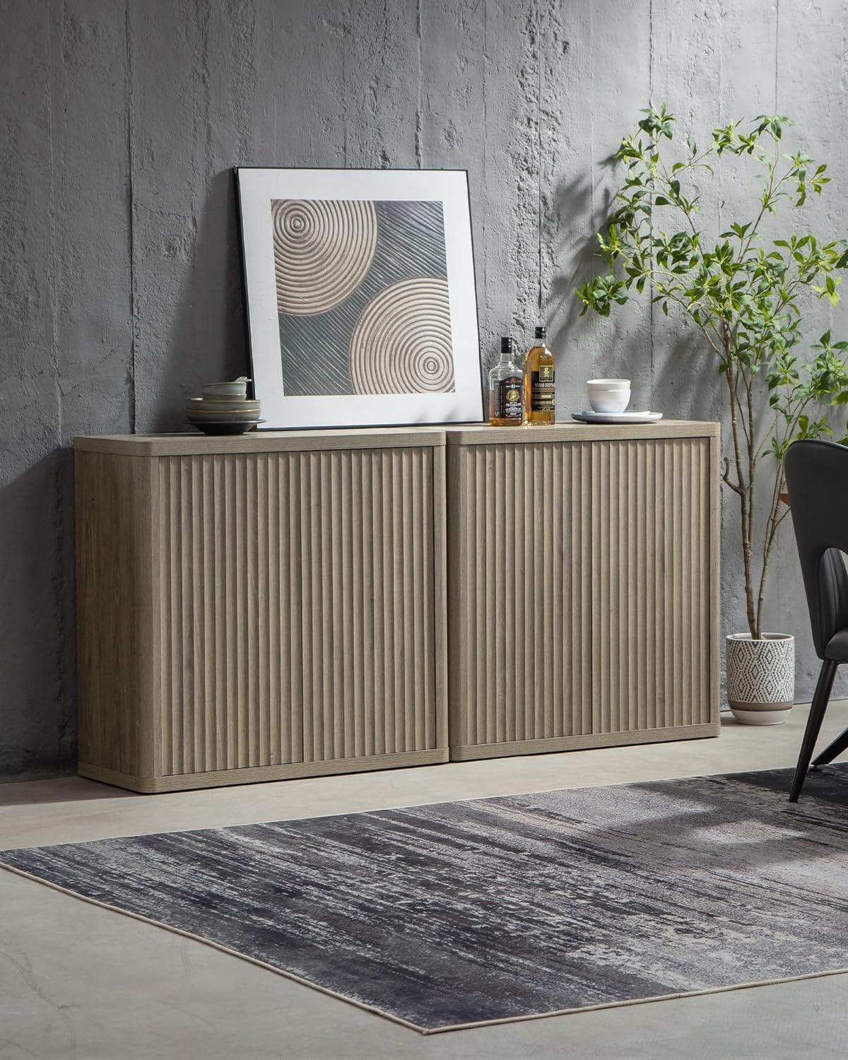 Modern wood buffet cabinet with decorative items, abstract art, and plant in minimalist room