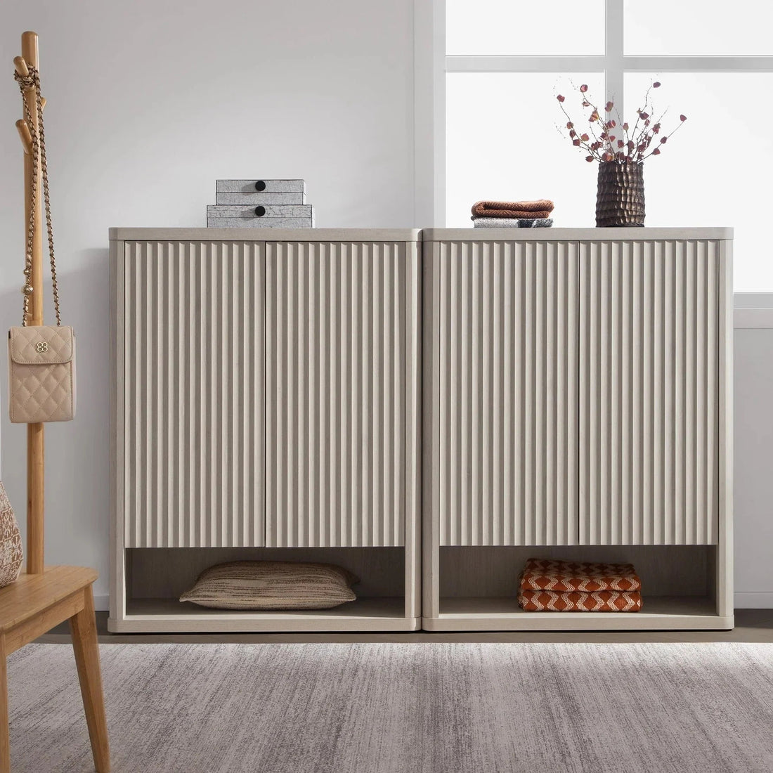 Modern wooden shoe storage cabinet with vertical grooves in a bright entryway