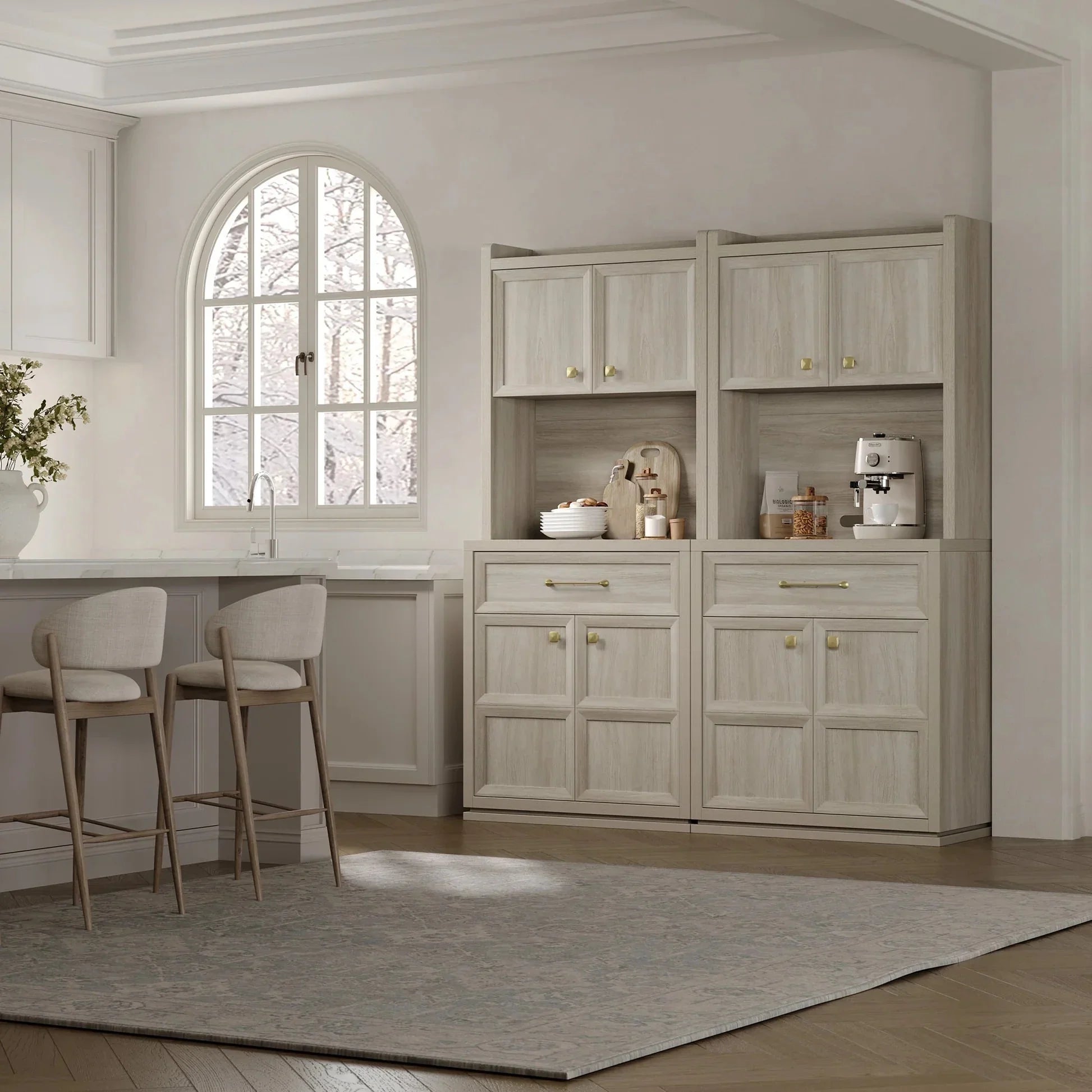 Light wood pantry cabinet in modern kitchen with coffee maker and bar stools