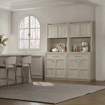 Light wood pantry cabinet in modern kitchen with coffee maker and bar stools