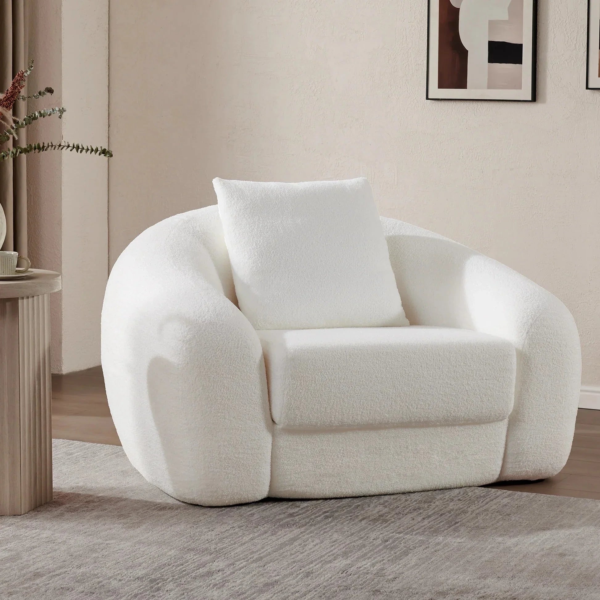 Modern living room with plush white boucle armchair and abstract wall art