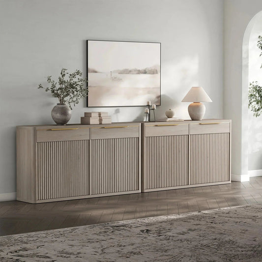 Modern fluted oak sideboard with decor, table lamp, and abstract art in a contemporary living room.