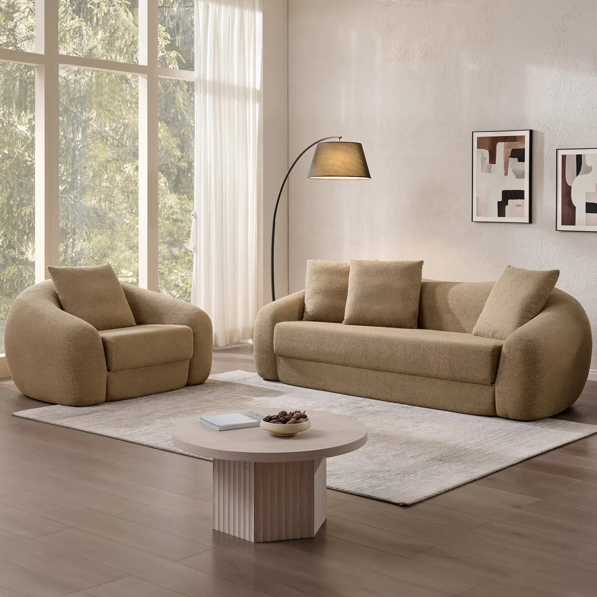 Modern living room with Nimbus accent chair, matching beige sofa, and round coffee table