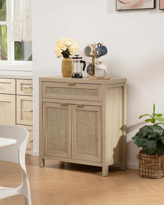 Light wood buffet cabinet with rattan doors, coffee mugs, French press, and vase of flowers