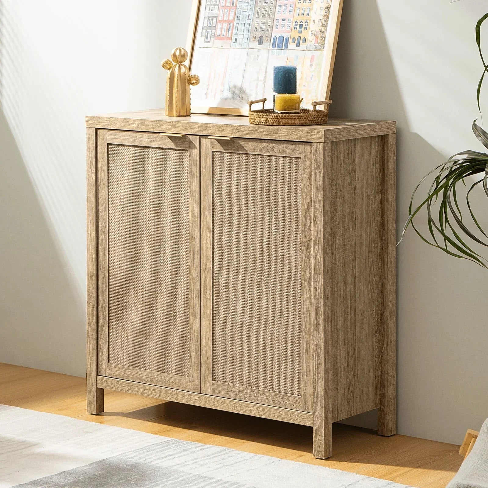 Modern light wood sideboard with cane doors, decorative objects, and framed art on top