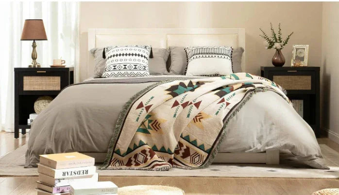 Modern bedroom with geometric bedding, decorative pillows, and bedside tables