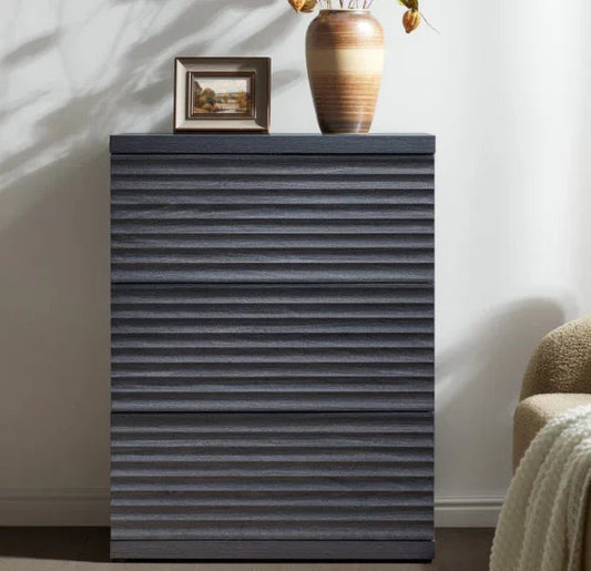 Modern dark wood chest of drawers with textured front, vase, and small framed artwork on top