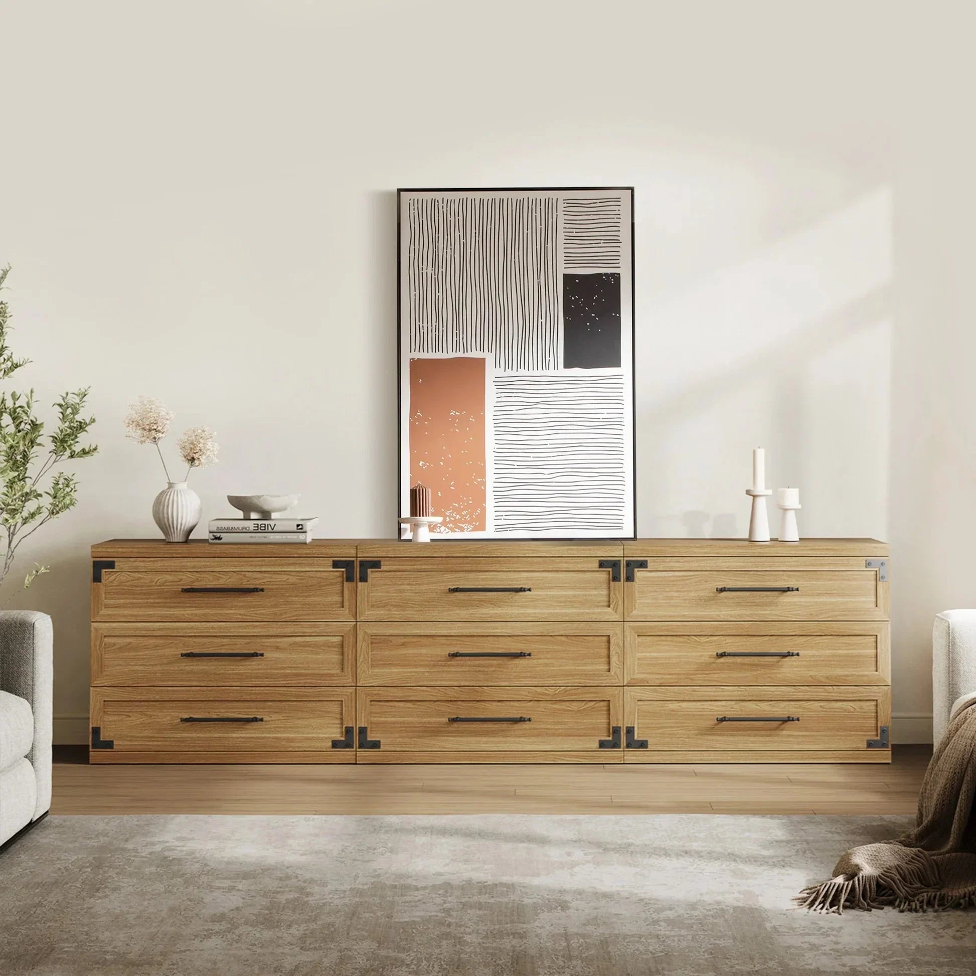 Modern wood dresser with metal handles, abstract wall art, and minimalist decor in living room