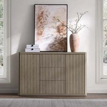 Modern ribbed wood sideboard with abstract art, decorative vase, and boxes in bright room