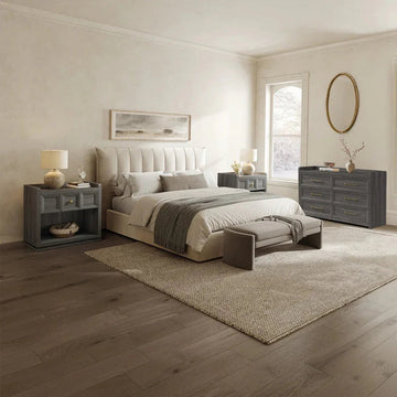 Modern bedroom with tufted bed, gray wood furniture, and neutral decor