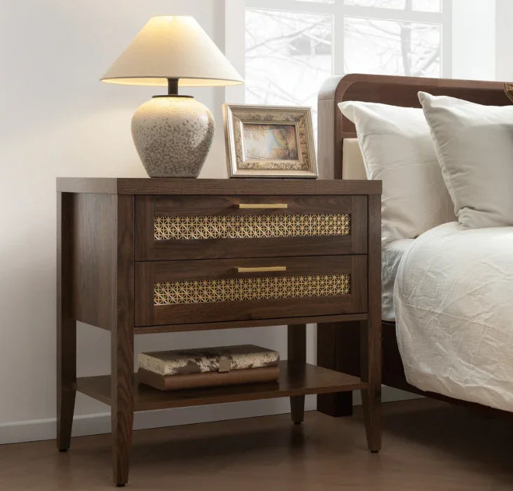 Modern wooden nightstand with brass accents, table lamp, picture frame, and decor, beside bed