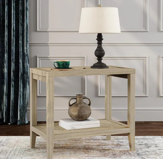 Modern wood console table with black lamp, green cup, rustic vase, and books in a stylish living room.