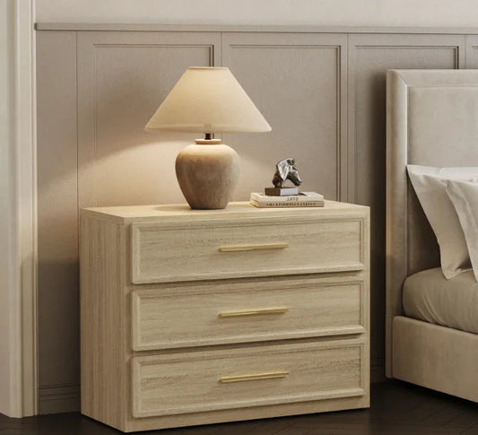 Modern bedroom with light wood nightstand, ceramic lamp, books, and upholstered bed