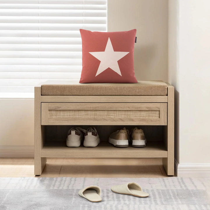 Wooden entryway bench with cushion, red star pillow, sneakers and slippers, bright window.