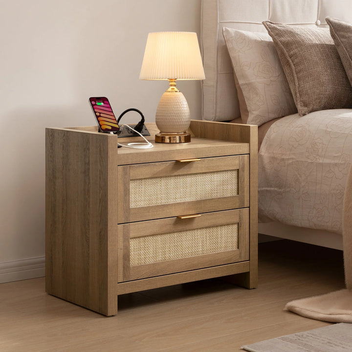 Wooden nightstand with lamp, phone, and charging station beside beige bed in modern bedroom