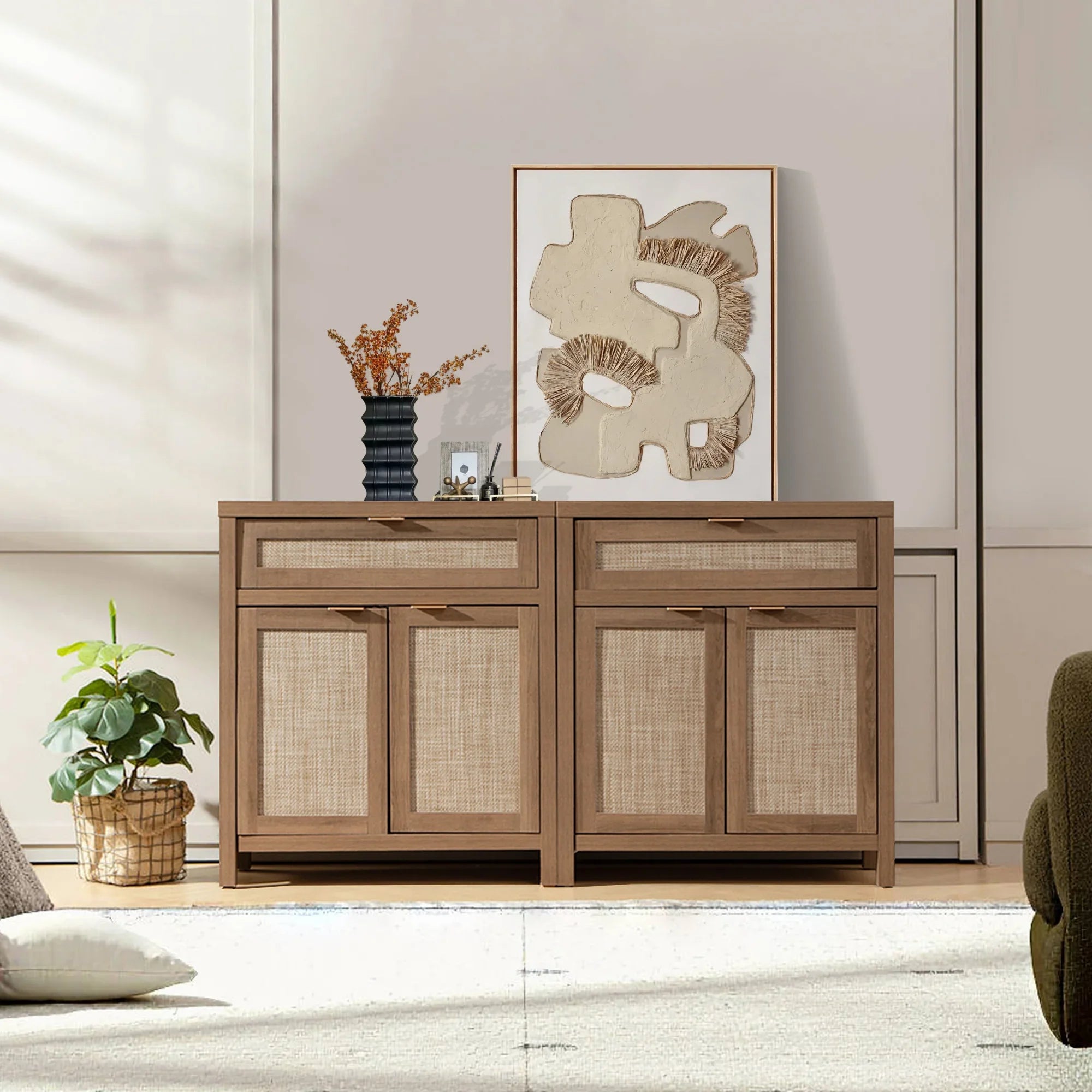 Modern rattan sideboard with abstract art, black vase, and plant in bright living room