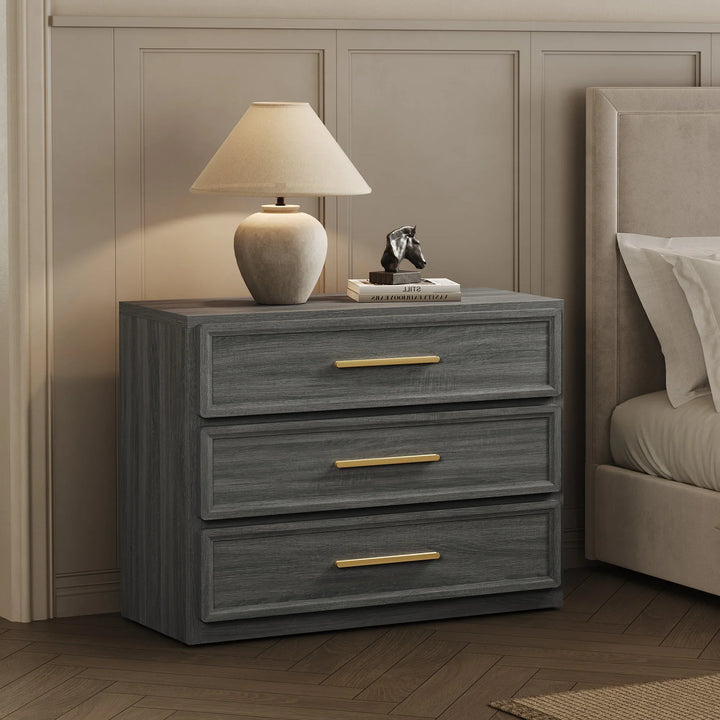 Modern grey wood nightstand with gold handles, table lamp, books, and art sculpture in bedroom