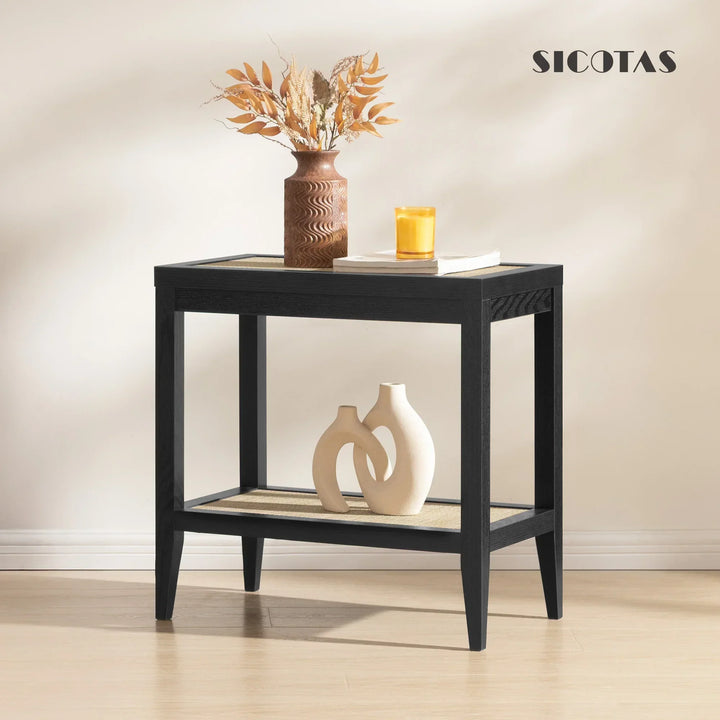 Modern black side table with decorative vases, candle, and dried floral arrangement in minimalist room