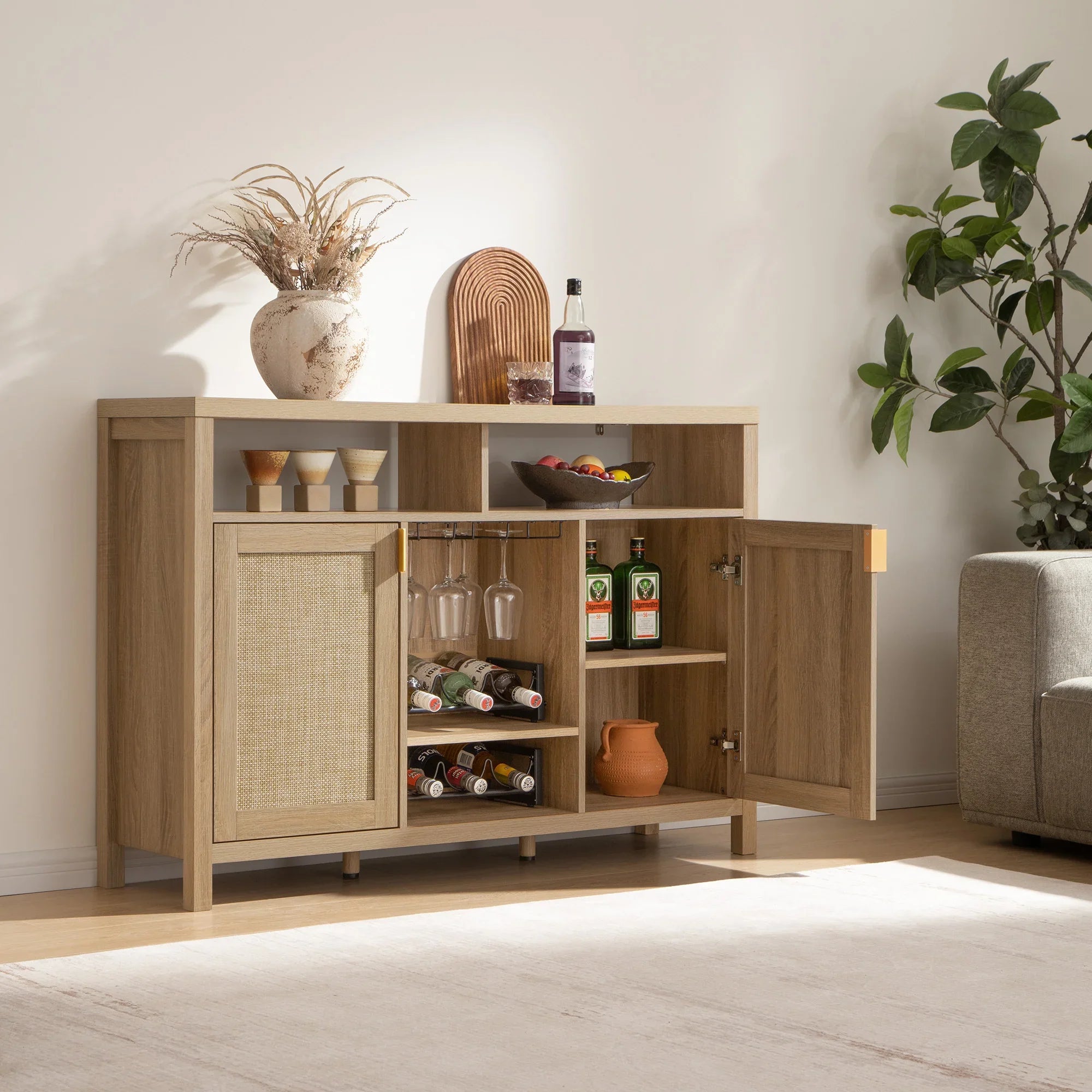 Modern wooden bar cabinet with wine bottles, glassware, decor, and indoor plant in living room