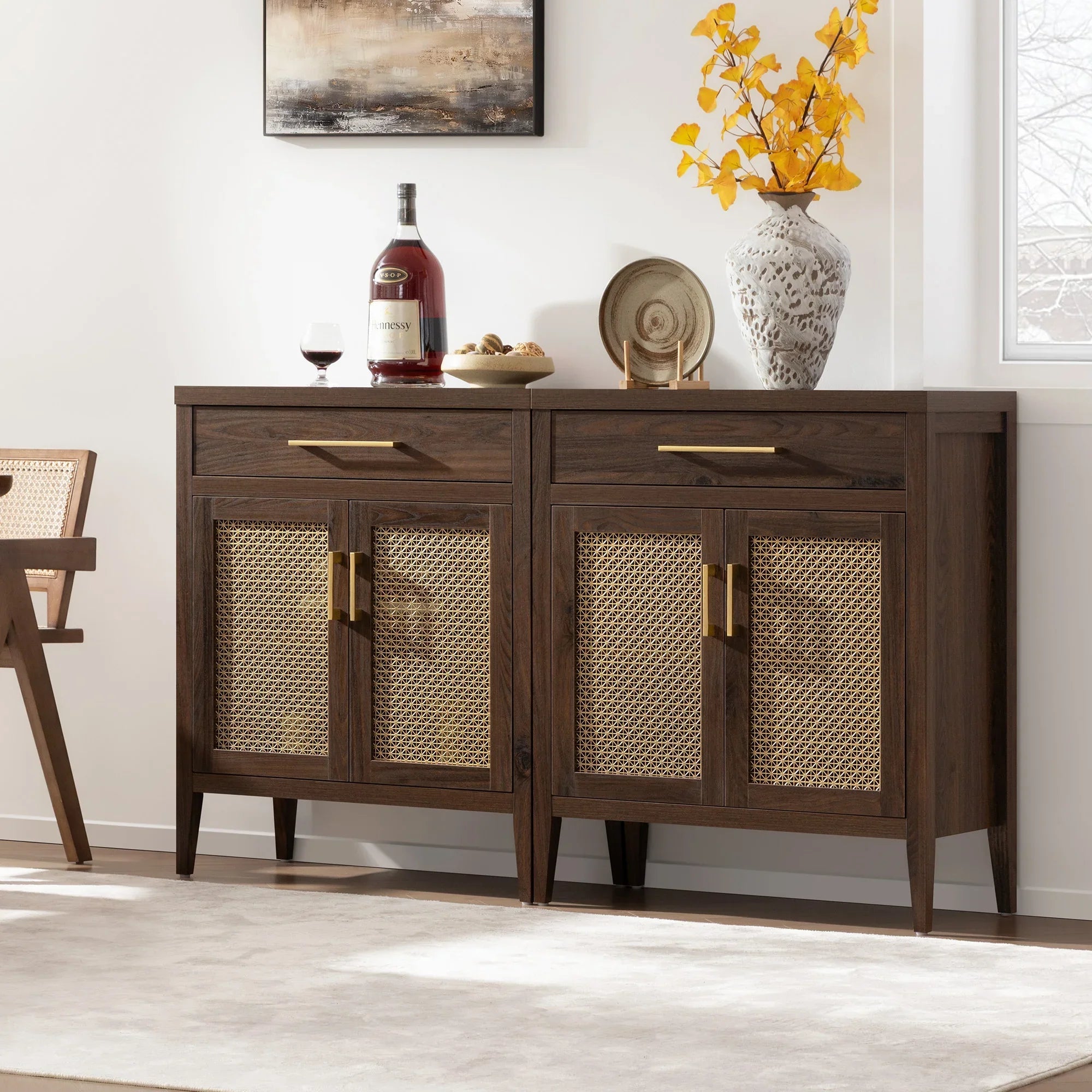 Mid-century modern sideboard with rattan doors, decor, and Hennessy bottle
