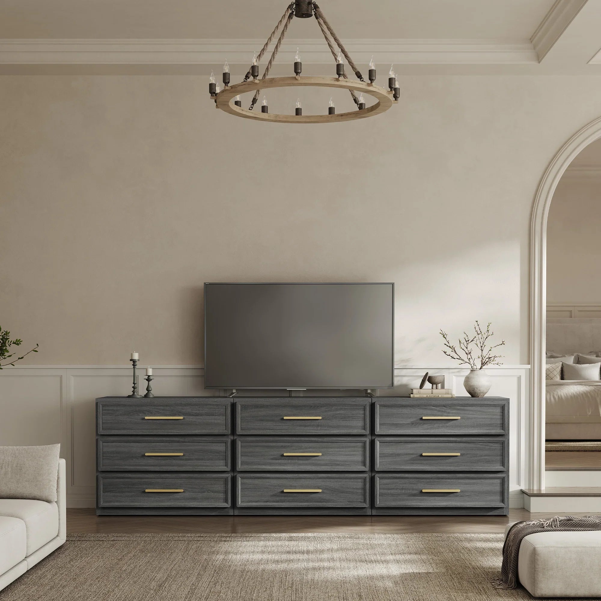Modern living room with dark wood TV console, flat-screen TV, and neutral decor accents.