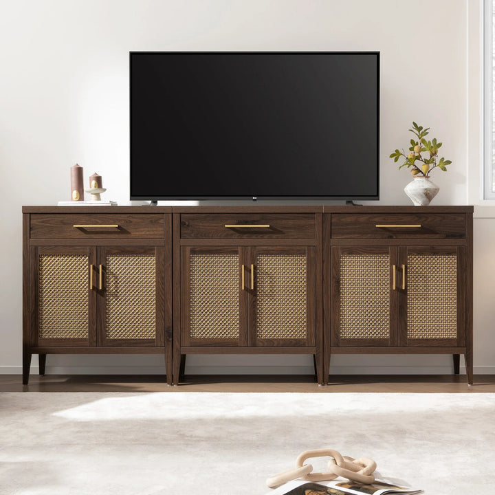 Modern TV stand with rattan cabinet doors, large flat screen TV, and decorative accents