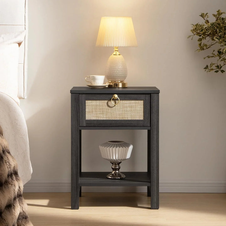 Modern black nightstand with woven drawer, ceramic lamp, teacup, and decor in bedroom