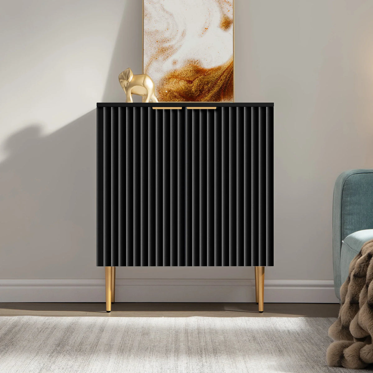 Modern black cabinet with gold legs, abstract art, gold elephant decor, minimalist room