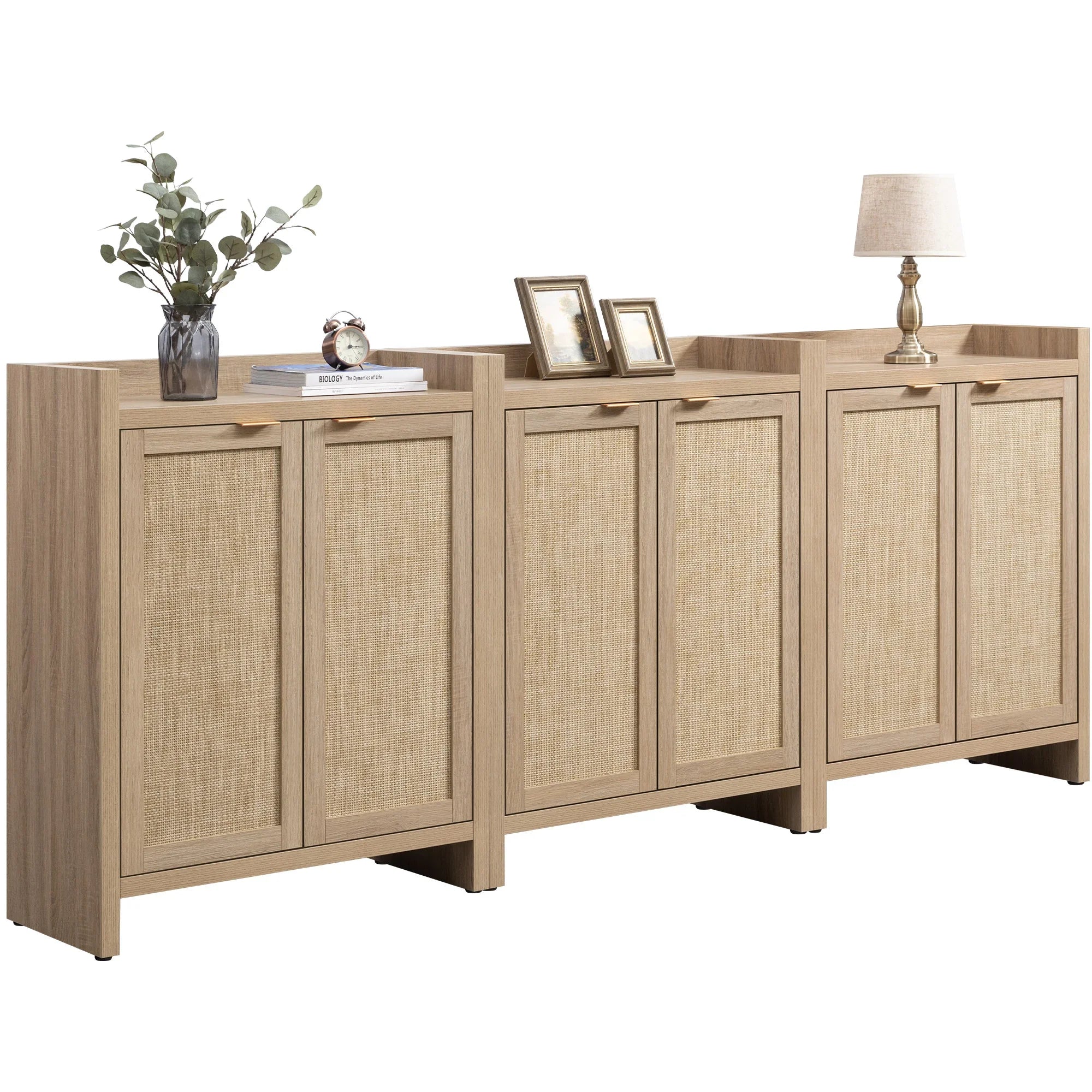 Modern wood sideboard with rattan cabinet doors, decor items, lamp, and framed photos