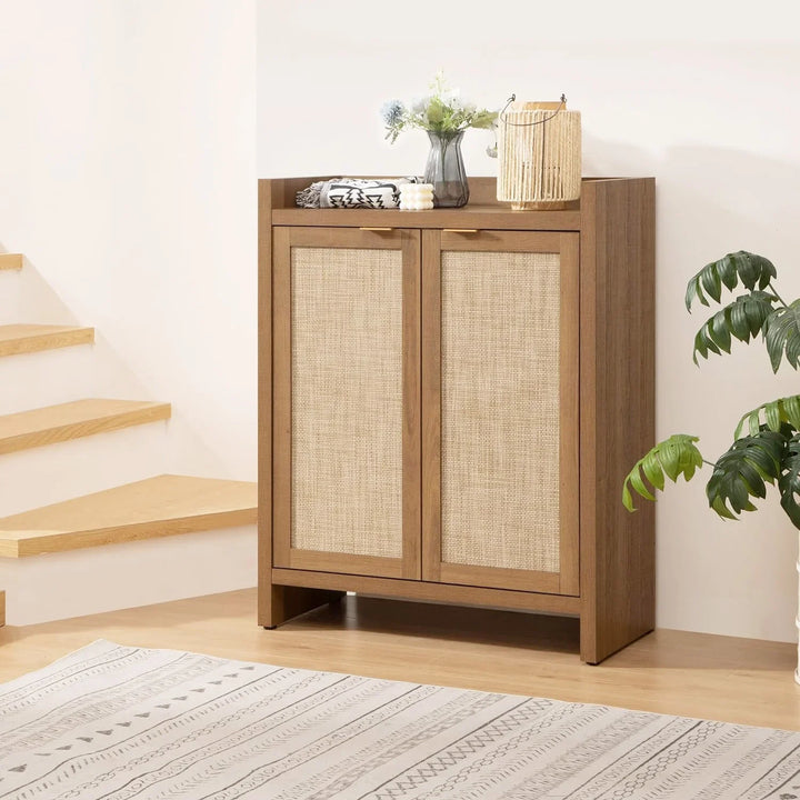 Modern wooden storage cabinet with woven rattan doors, decor, and plant in a bright room