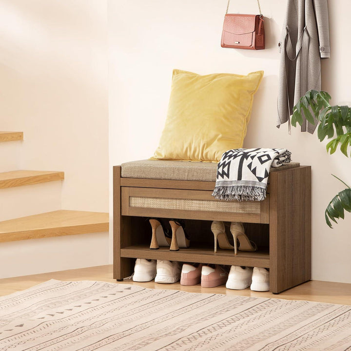 Modern entryway with wooden shoe bench, yellow cushion, patterned throw, and organized shoes underneath