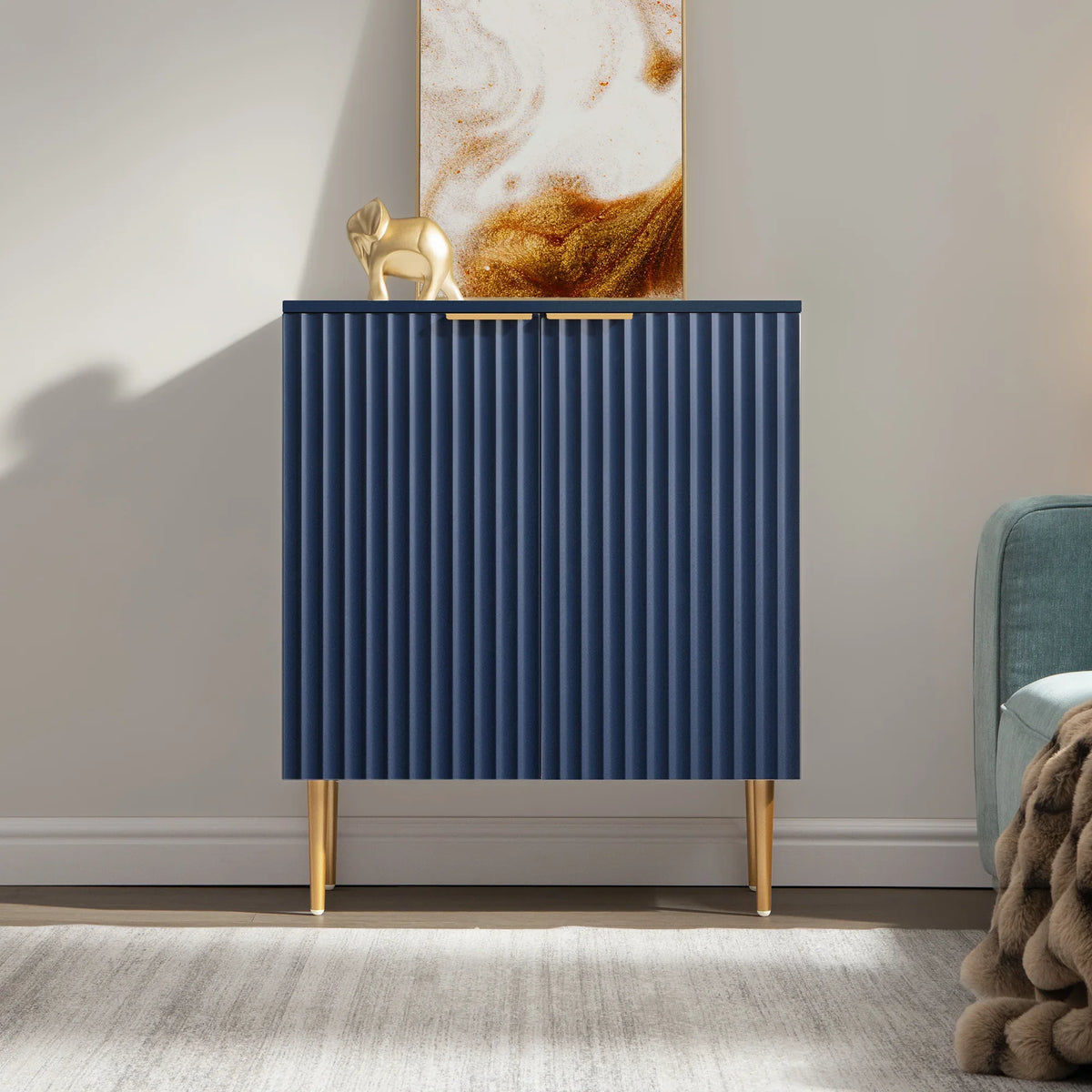 Modern blue cabinet with gold legs and handles, gold elephant decor, abstract art background