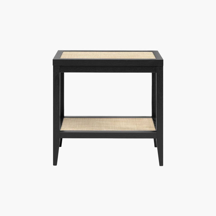 Black wood and rattan side table with open shelf on white background