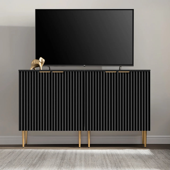 Modern black TV stand with gold legs and decor elephant, flat screen TV on top
