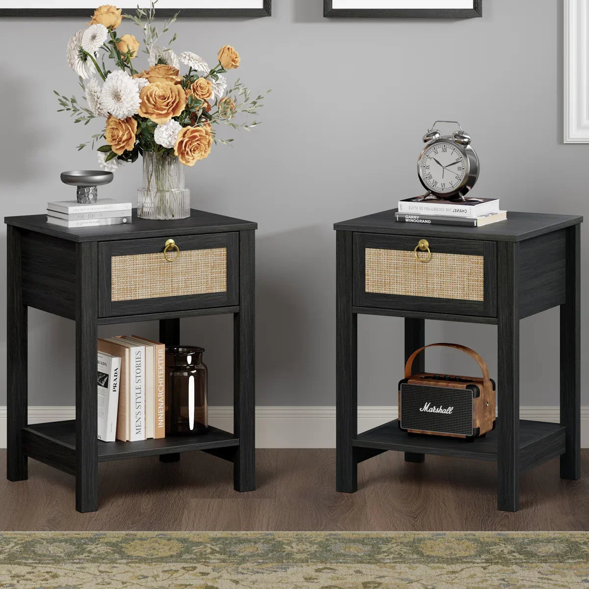 Pair of black nightstands with rattan drawers, books, clock, flowers and decor accents