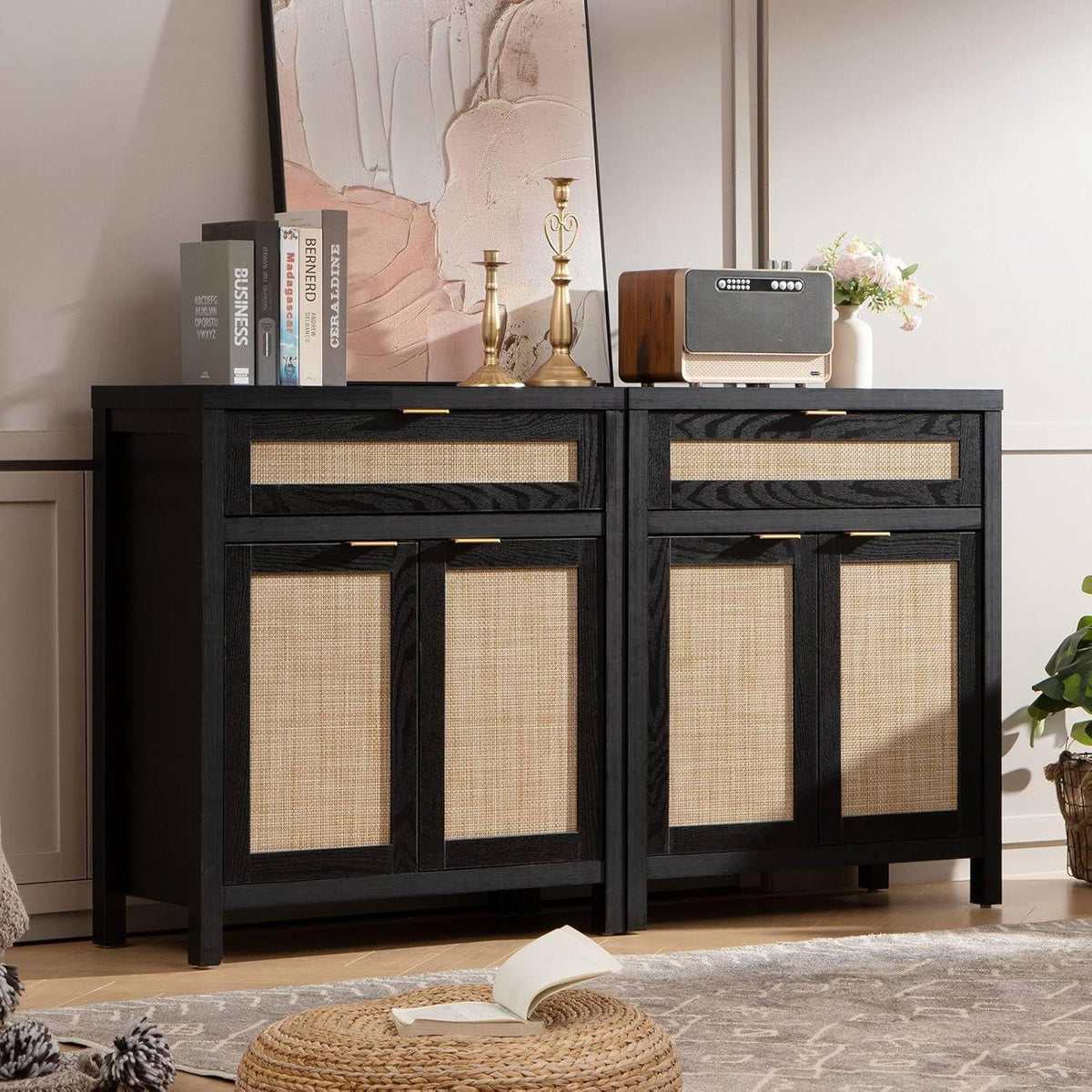 Black sideboard cabinet with rattan panels, books, gold candlesticks, radio, and decor in modern living room