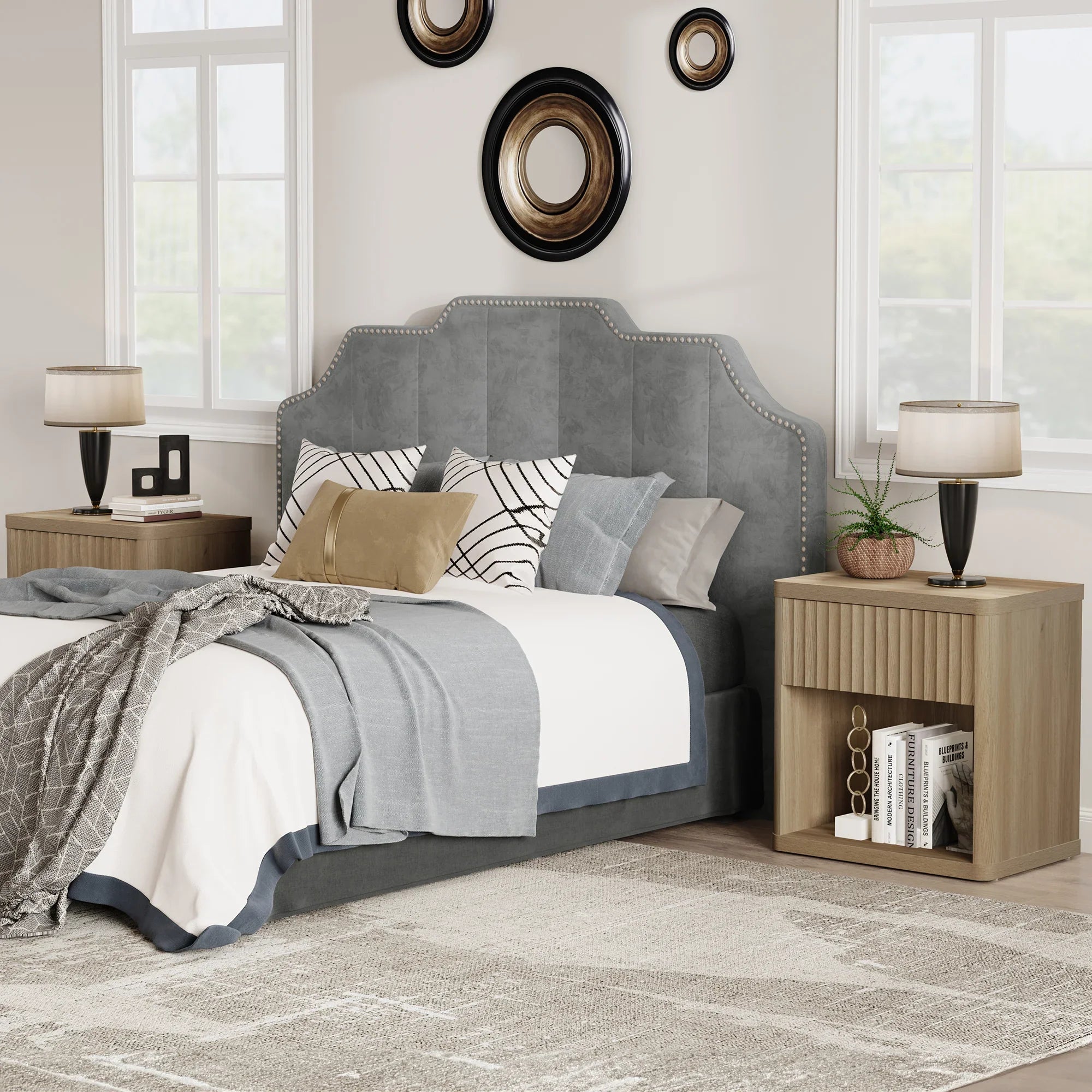 Modern bedroom with gray upholstered bed, wood nightstands, round wall mirrors, and soft lighting