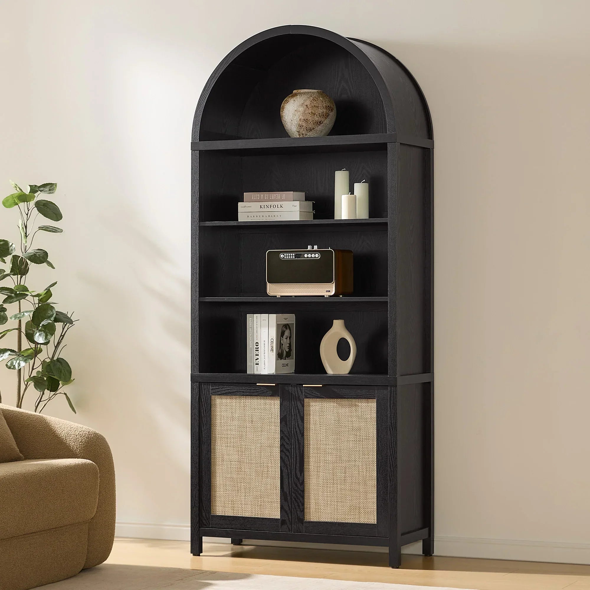 Modern black arched bookshelf with decor, books, and radio in a minimalist living room