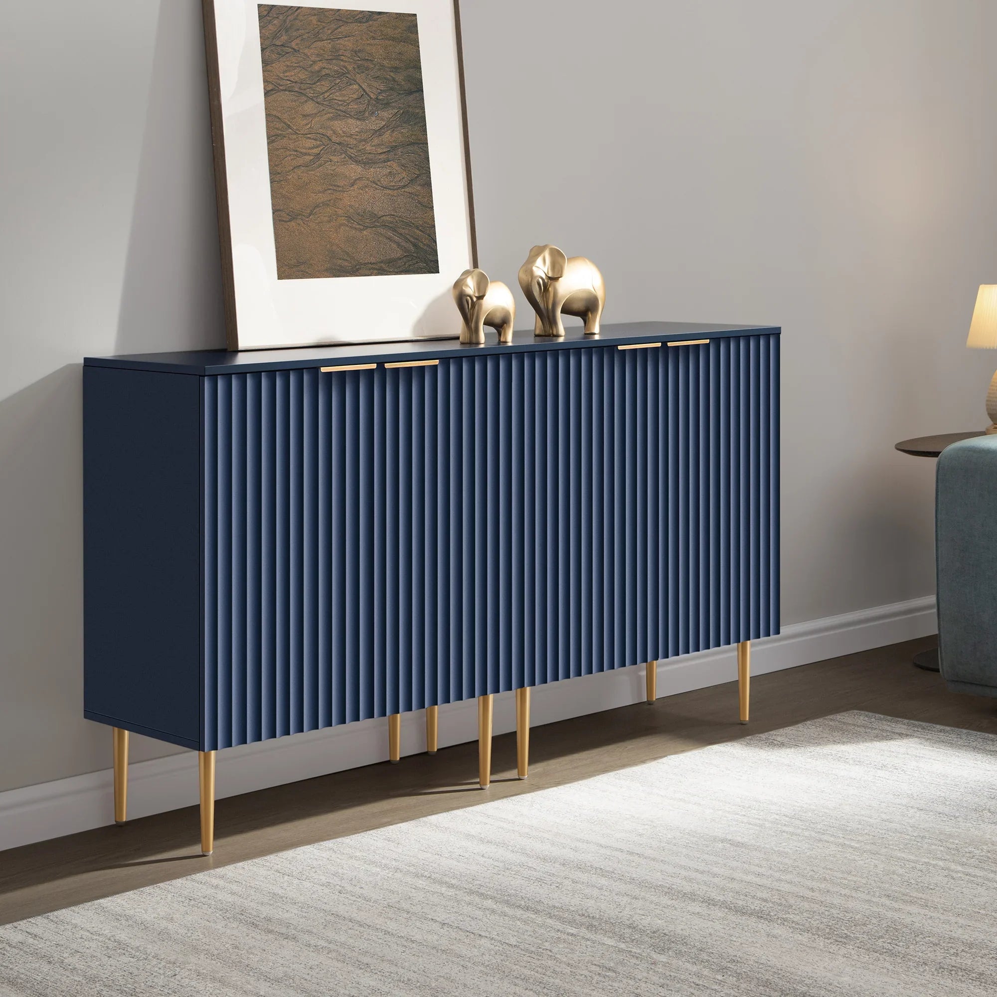 Modern blue sideboard with gold legs, art print, gold elephant decor in living room