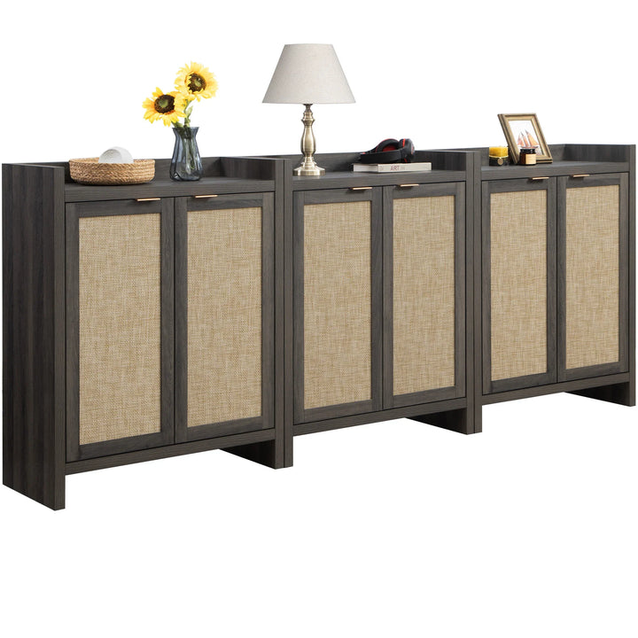 Modern wood sideboard with rattan doors, lamp, sunflowers, decor, and books on top