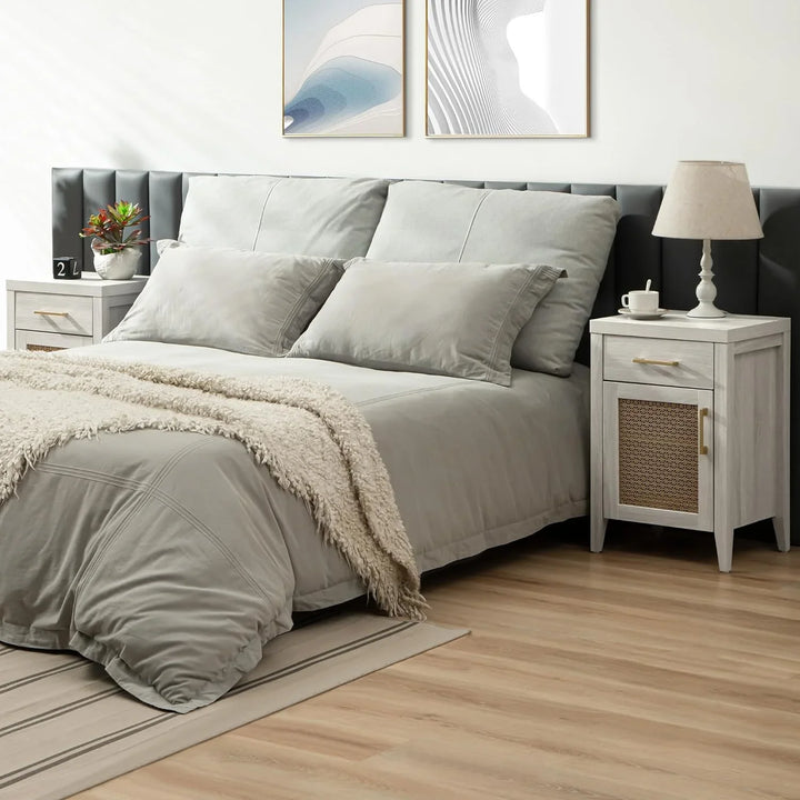 Modern bedroom with gray bedding, wooden nightstands, table lamp, and abstract wall art