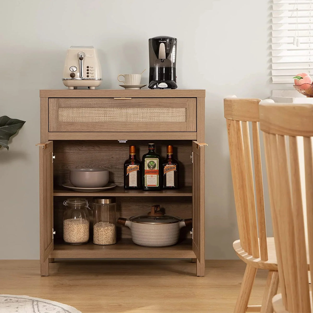 Modern kitchen sideboard with toaster, coffee maker, glass jars, and liquor bottles