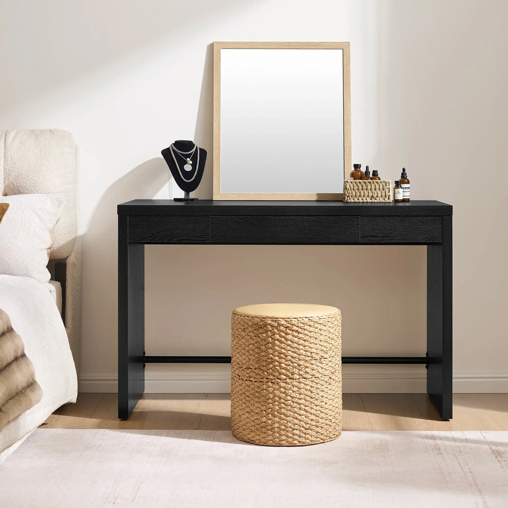 Black console table with decorative items in a bedroom setting